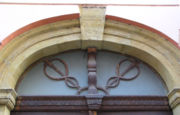 Two caduceuses without wings as decoration of door portal in Ztracen� street in Olomouc (Czech Republic).